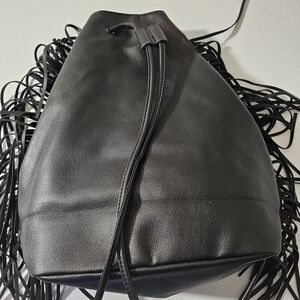 This is a Victoria's Secret black faux leather fringe drawstring backpack.